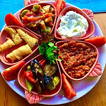 A vibrant platter of appetizers and dips